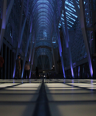 Dimly lit modern architectural interior with illuminated floor panels.