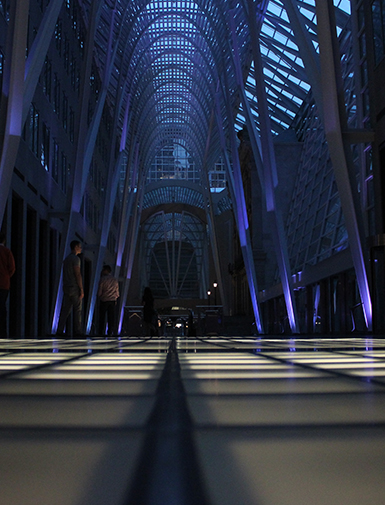 Dimly lit modern architectural interior with illuminated floor panels.